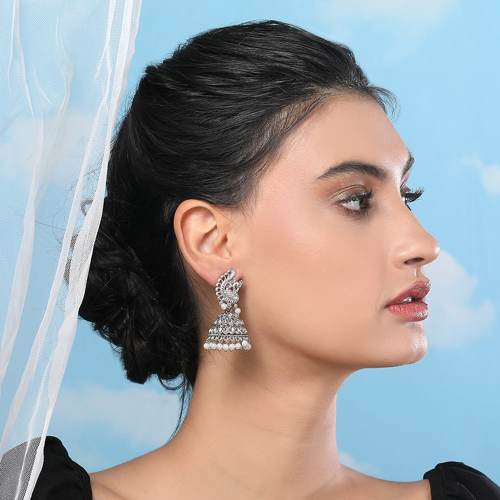 Lady wearing silver-plated crystal peacock pattern jhumka earrings with pearl drops, Indian ethnic traditional jewellery