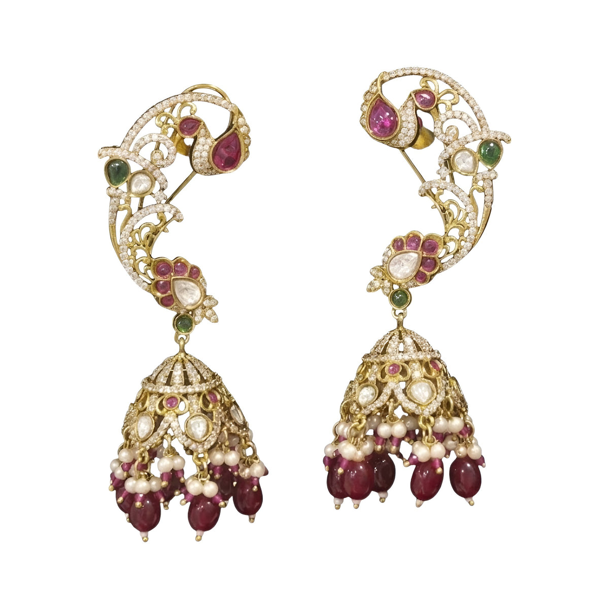 Gold plated ruby maroon ear cuff peacock jhumka earrings with American diamond stones, maroon beads and pearl hangings on a white background