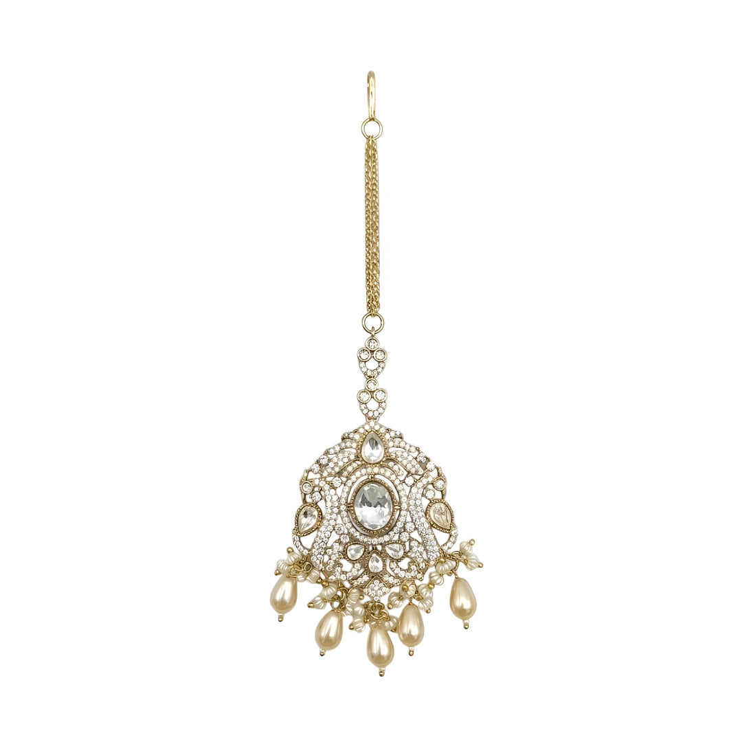 Gold plated Kundan Maang Tikka with white stone, crystal detailing and pearl drops for bridal wedding and traditional ethnic wear.