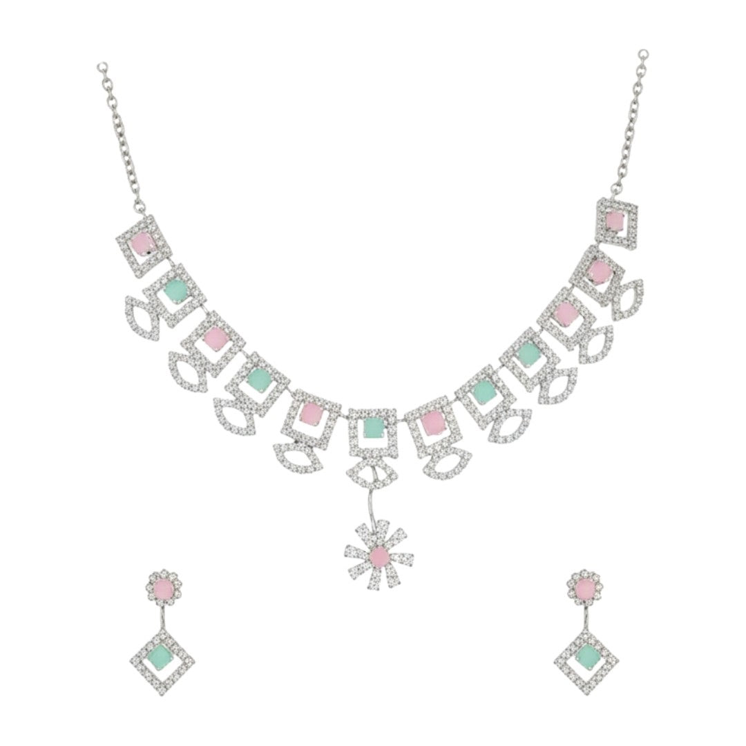 "Geometric pastel stone necklace and earring set displayed on a black velvet stand with floral centerpiece"