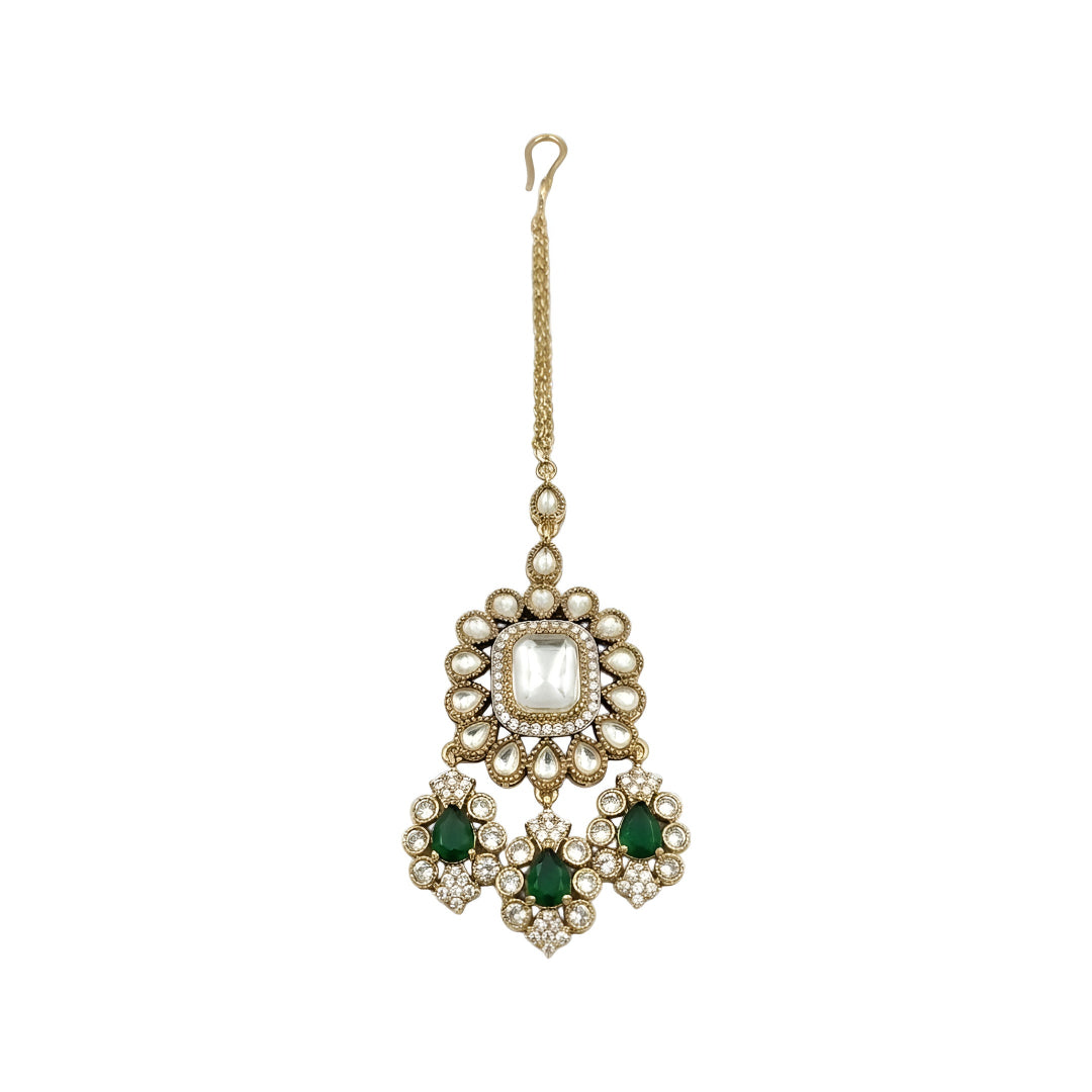 Gold-plated Kundan Maang Tikka featuring a square white center stone with emerald green teardrop stones and intricate floral detailing for bridal and festive wear.