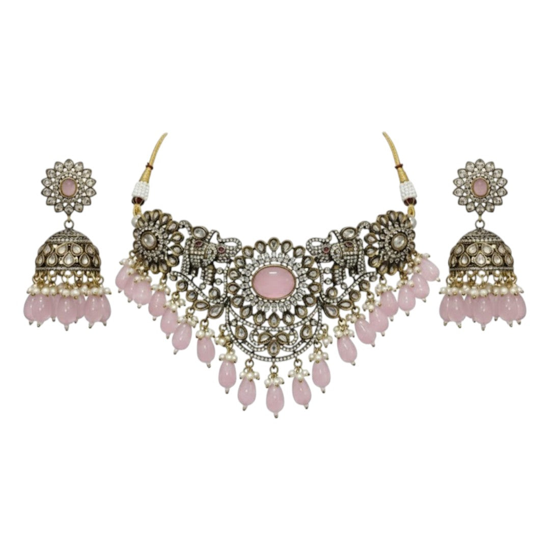 Antique oxidized choker necklace set with pink beads and floral motifs, paired with matching jhumka earrings โ traditional Indian jewelry
