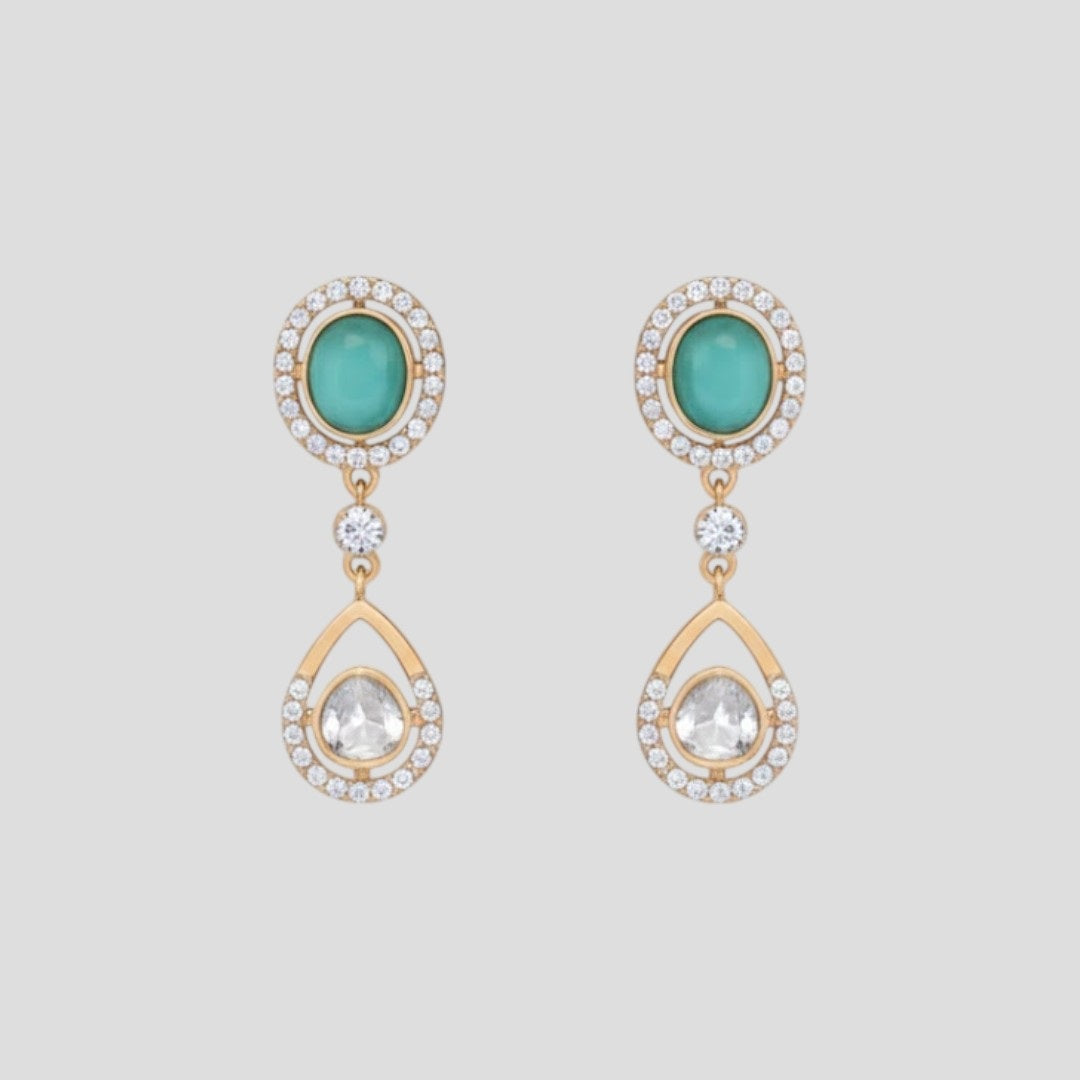 “Gold-plated necklace and matching earrings set with turquoise stones and crystal-accented teardrop pendants.”