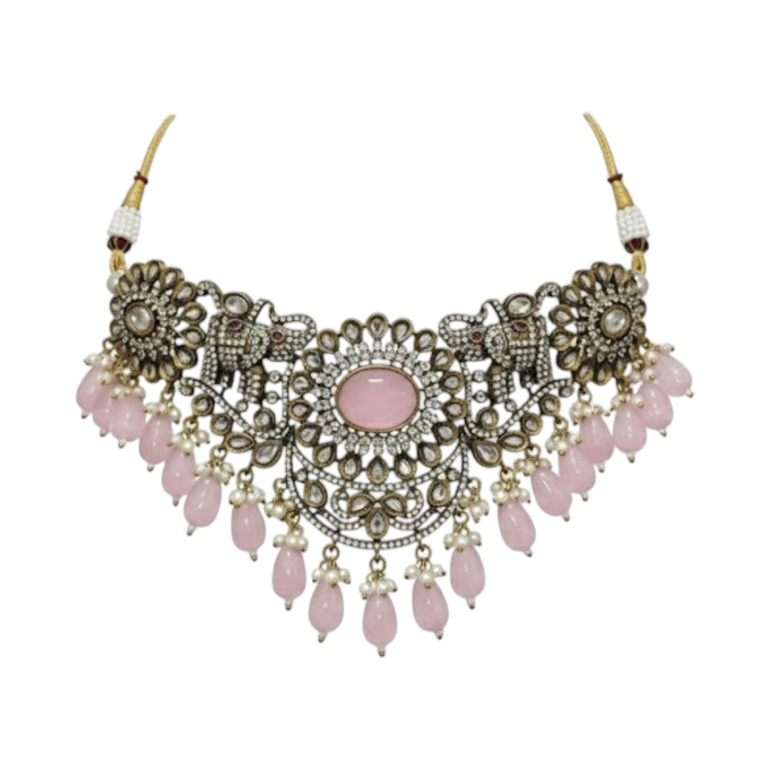 Antique oxidized choker necklace set with pink beads and floral motifs, paired with matching jhumka earrings โ traditional Indian jewelry