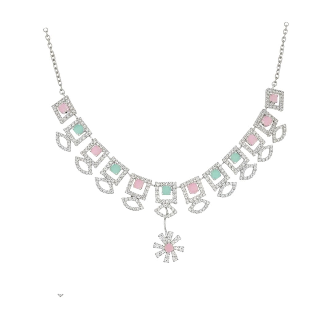 "Geometric pastel stone necklace and earring set displayed on a black velvet stand with floral centerpiece"