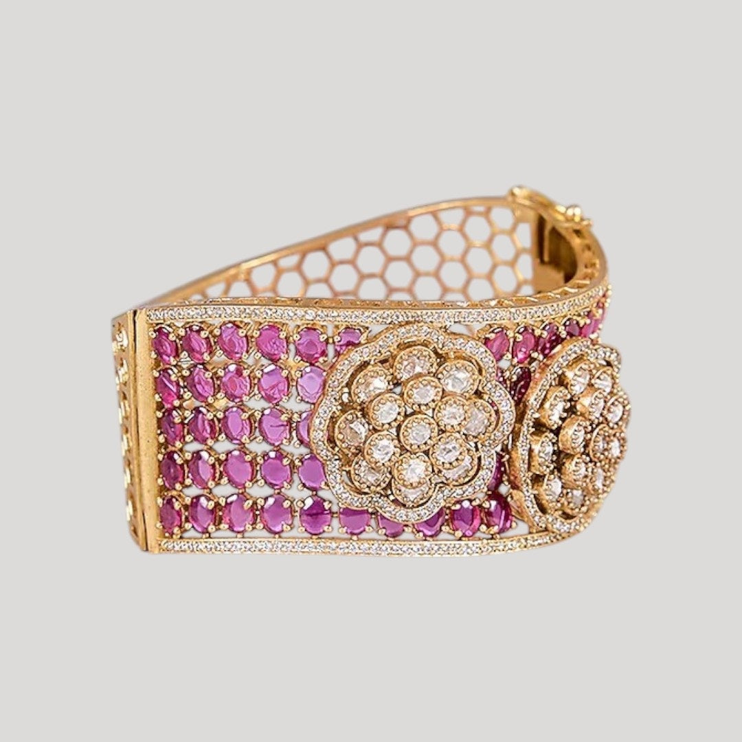 Woman wearing gold-plated ruby kundan floral bracelet kada