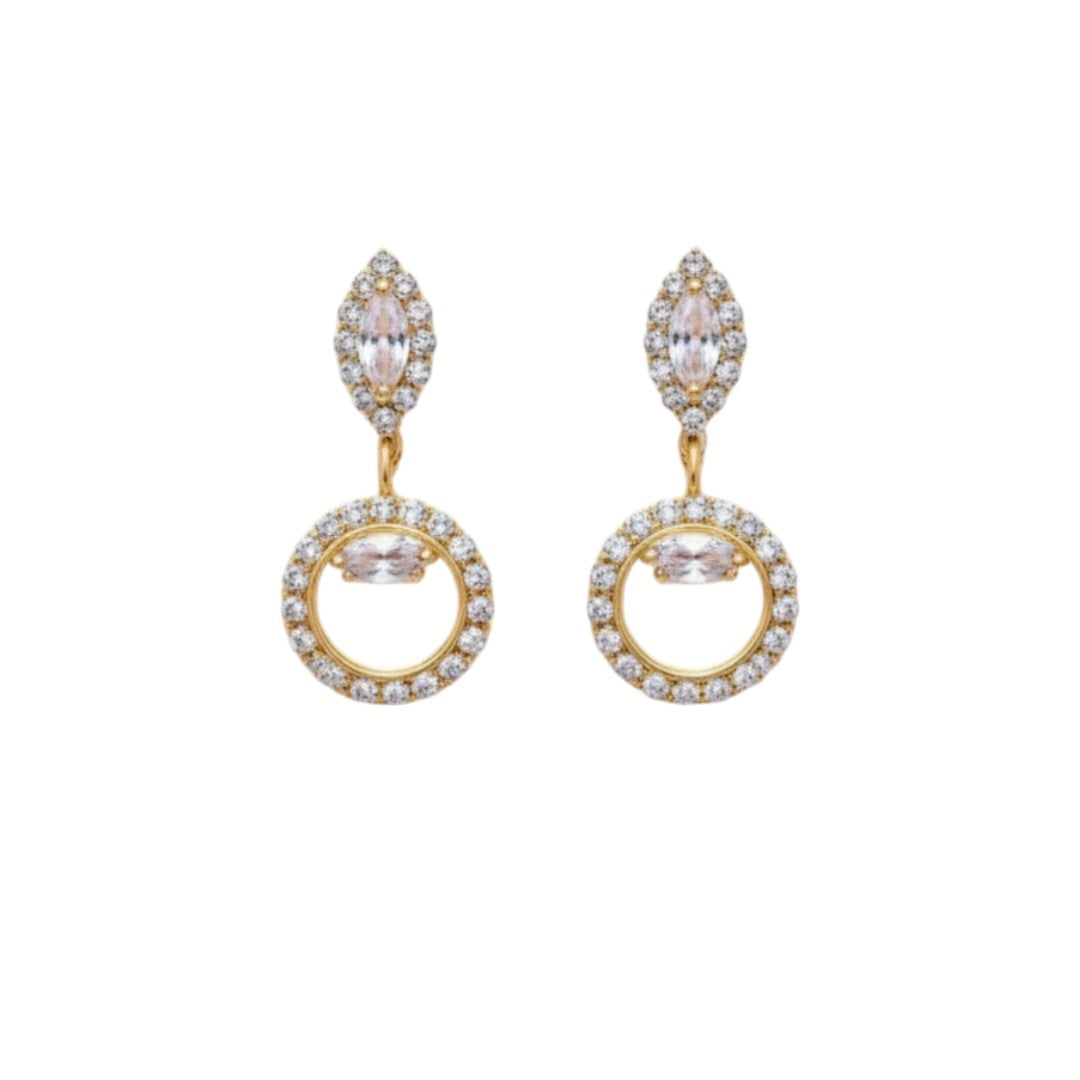 "Gold-tone necklace and earring set with circular and leaf motifs displayed on black velvet stand"