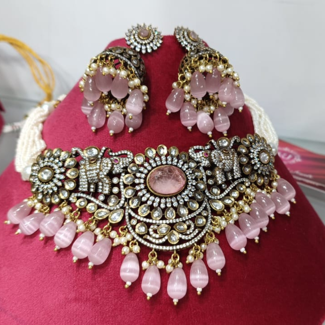 "Antique oxidized choker necklace set with pink beads and floral motifs, paired with matching jhumka earrings โ traditional Indian jewelry"