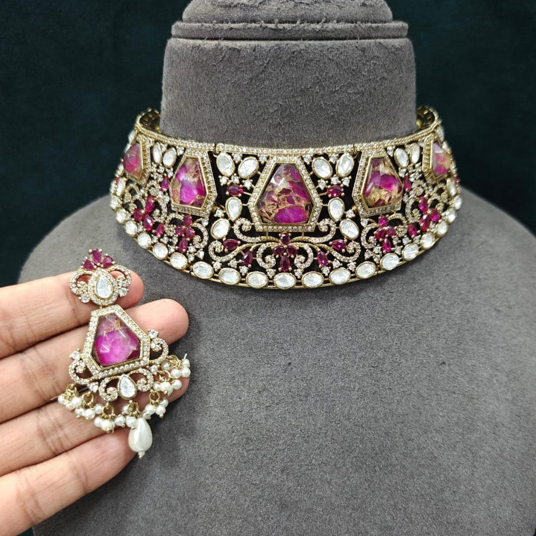 Royal pink Kundan bridal choker necklace set with matching earrings featuring white Kundan stones, floral detailing, pink statement stones, and pearl drop accents.