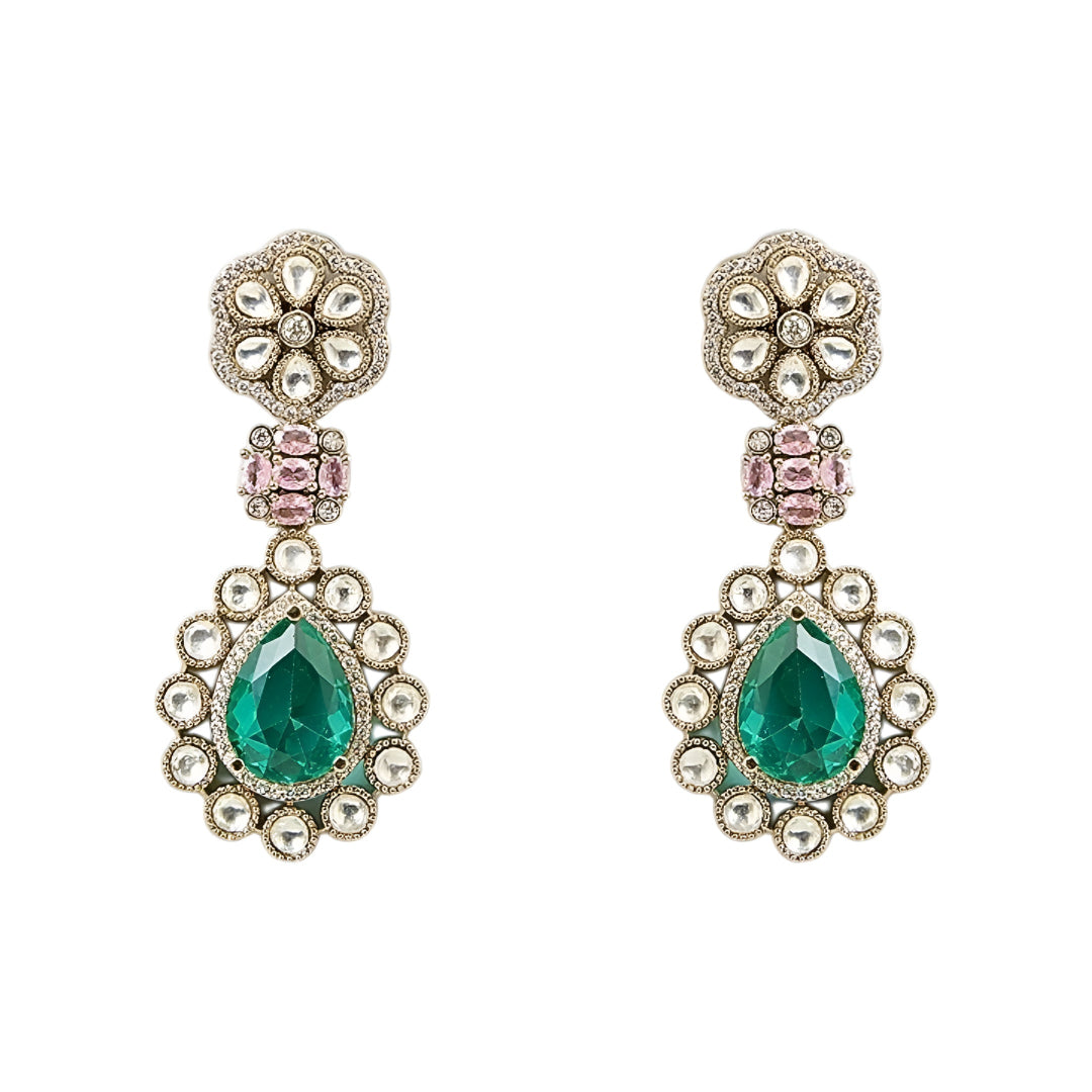 Traditional emerald green kundan choker necklace set with floral motifs and matching drop earrings for bridal and festive wear.