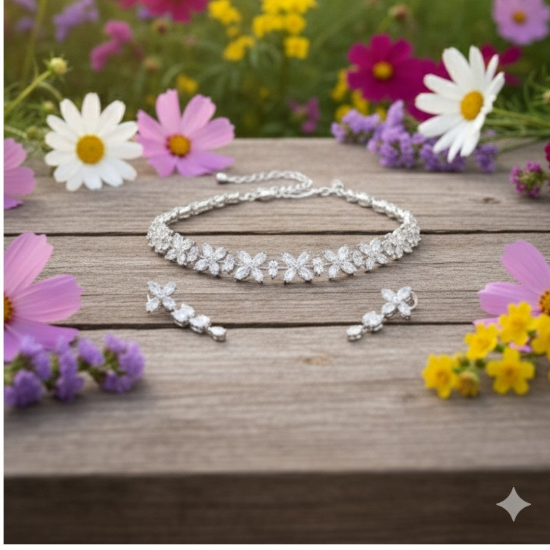 Elegant floral silver choker necklace set with matching earrings displayed on red velvet jewelry stand