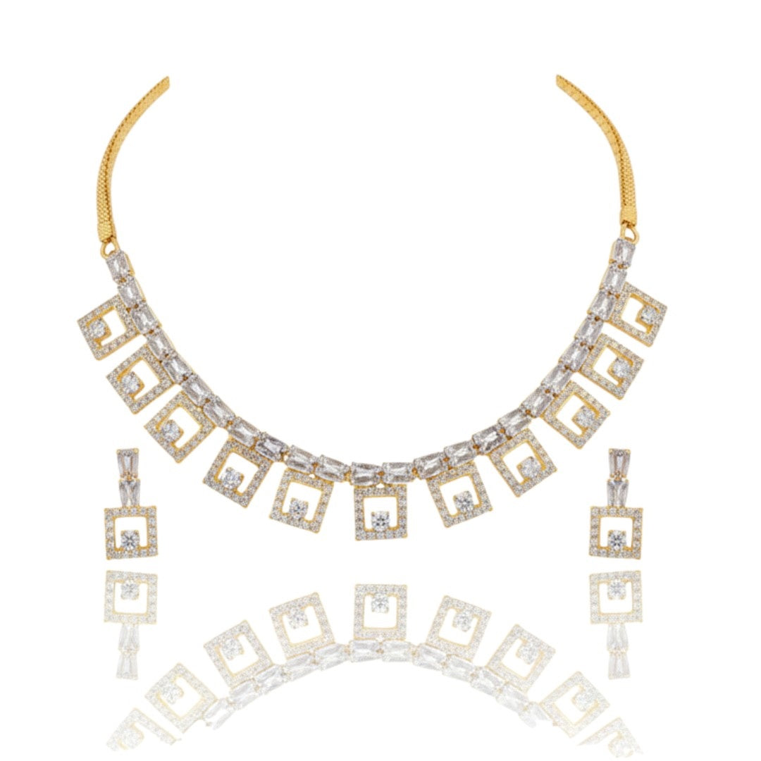 "Gold-plated American diamond necklace set with geometric square design and matching earrings on red display stand"