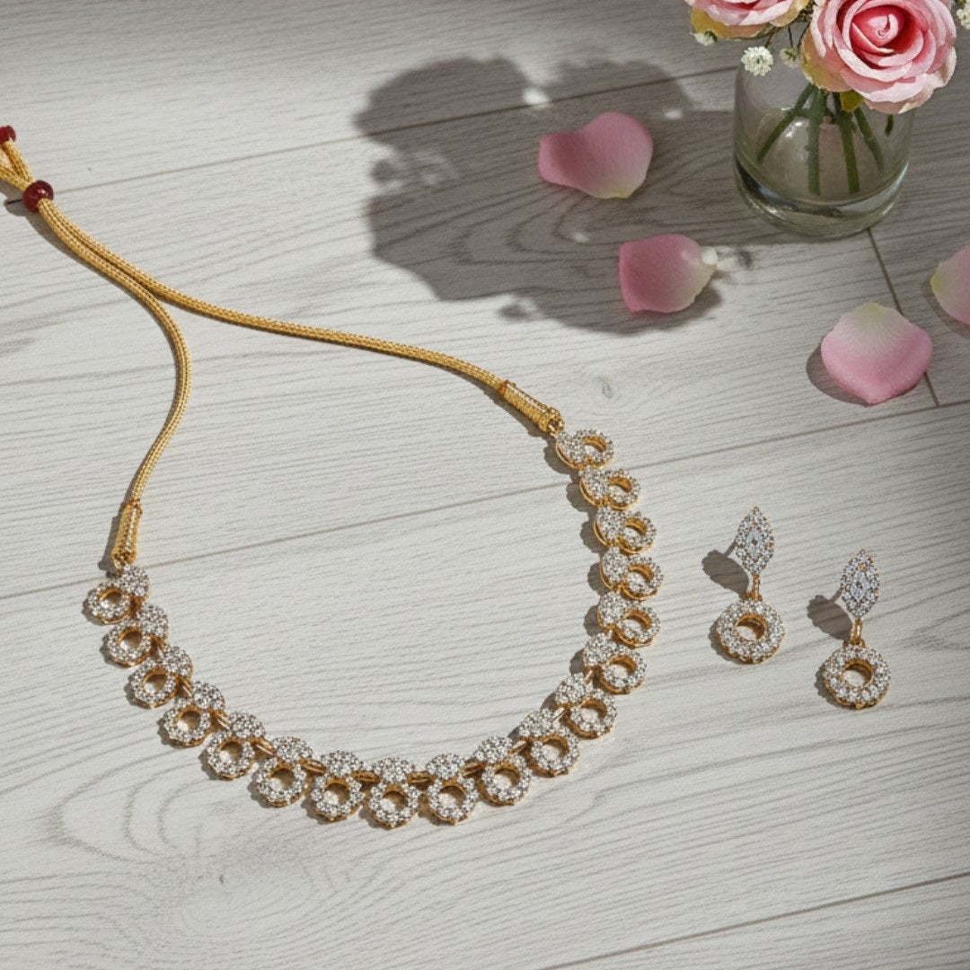 "Gold-plated diamond necklace set with circular motifs and drop earrings on black velvet stand – ideal for party or festive wear."