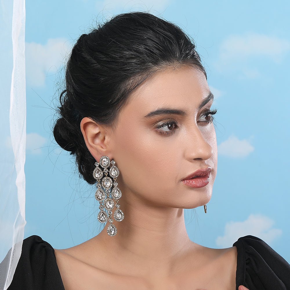 Buy Aviana Statement Crystal Chandelier Earrings in Silver Finish - Auraa Trends - Chandelier Earrings - - Auraa Trends - Model sporting silver chandelier earrings featuring layered crystal drops, ideal for weddings or night parties