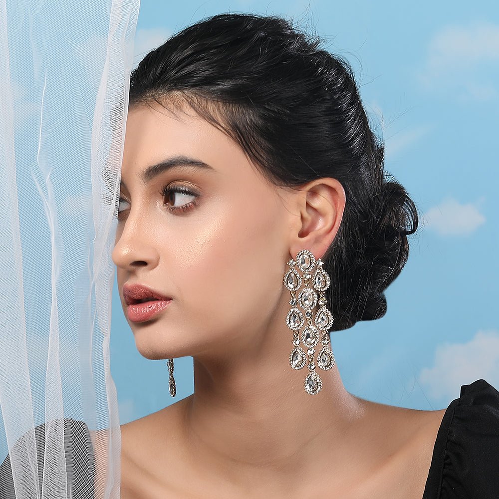 Buy Aviana Statement Crystal Chandelier Earrings in Silver Finish - Auraa Trends - Chandelier Earrings - - Auraa Trends - Model sporting silver chandelier earrings featuring layered crystal drops, ideal for weddings or night parties