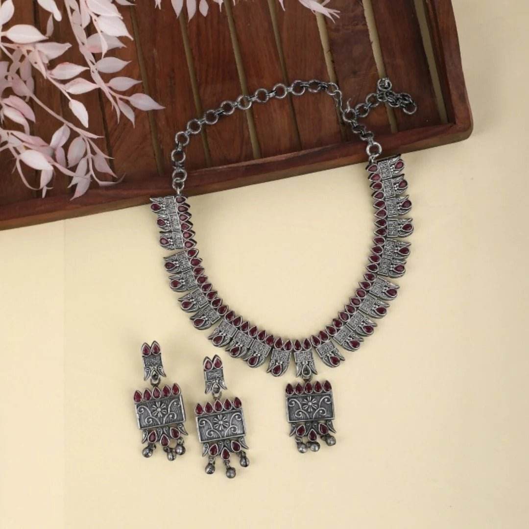 Buy Aviana Tribal Oxidized Silver-Plated Necklace Set Featuring Red Stone Embellishments and Dangling Drop Earrings - Auraa Trends