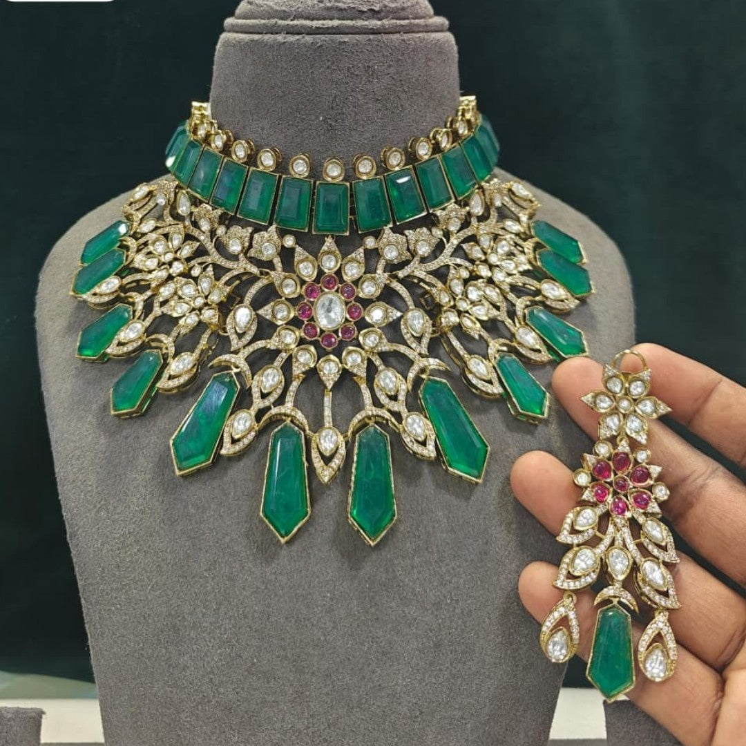 Gold plated emerald green kundan bridal choker necklace set with ruby-pink flower centre, green drops and matching chandelier earrings