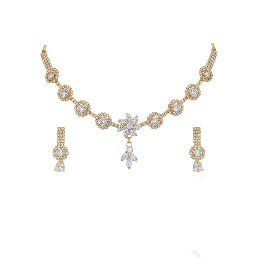 "Gold-plated floral diamond necklace set with matching earrings displayed on red velvet stand – ideal for weddings and festive occasions."