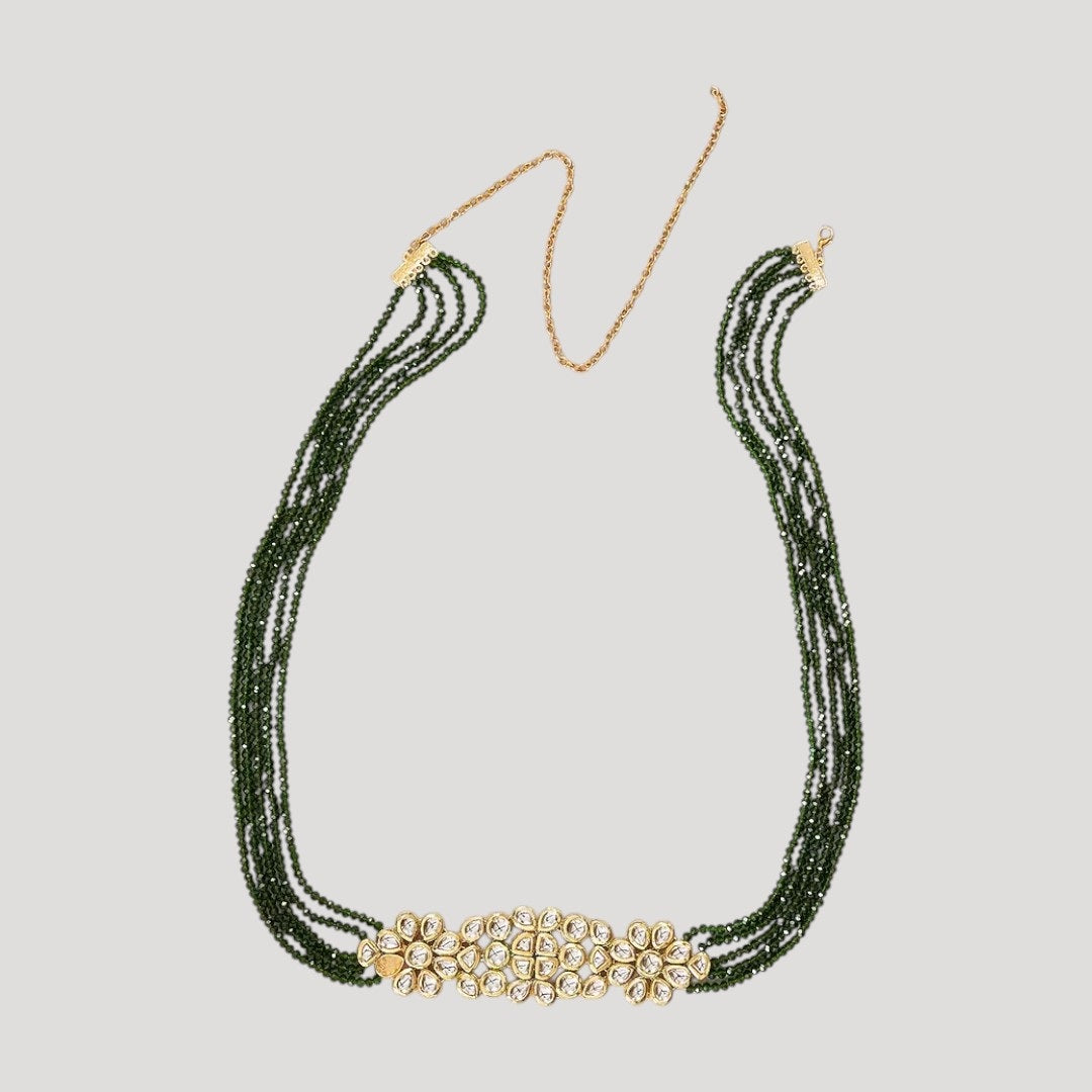 "Green beaded multi-layer kamar bandh with a central gold-tone Kundan floral design and adjustable golden waist dori."