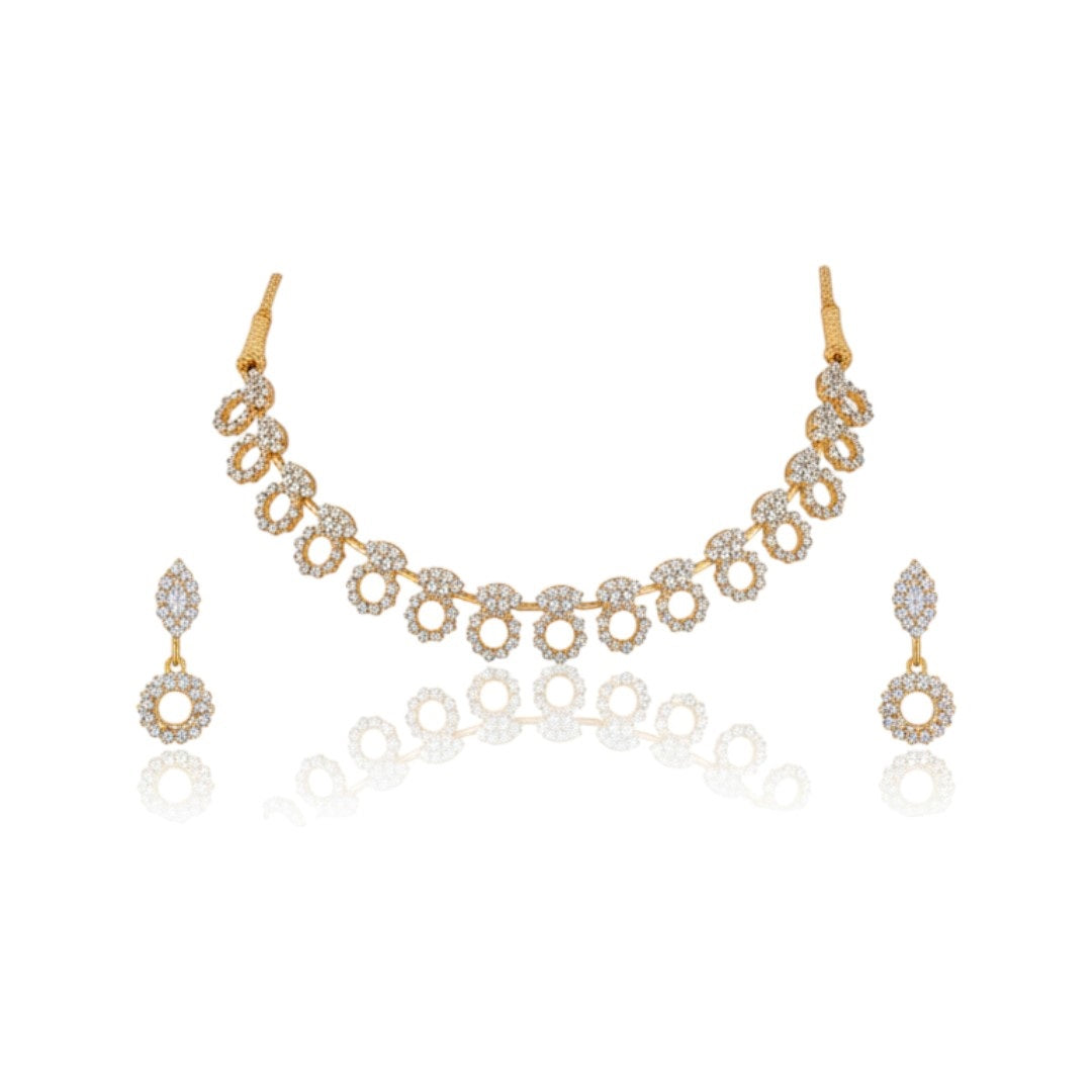"Gold-plated diamond necklace set with circular motifs and drop earrings on black velvet stand – ideal for party or festive wear."