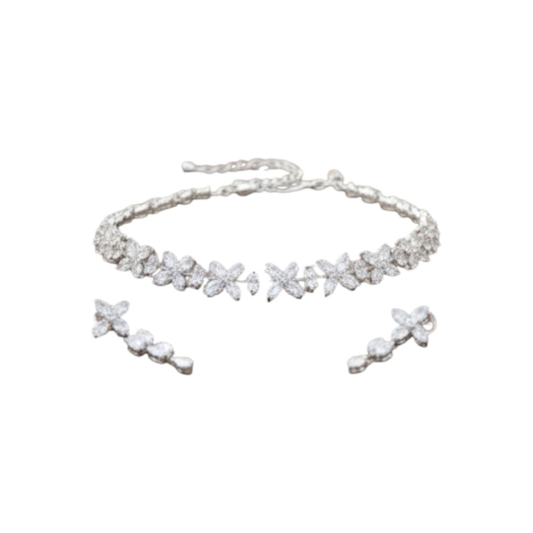 Elegant floral silver choker necklace set with matching earrings displayed on red velvet jewelry stand