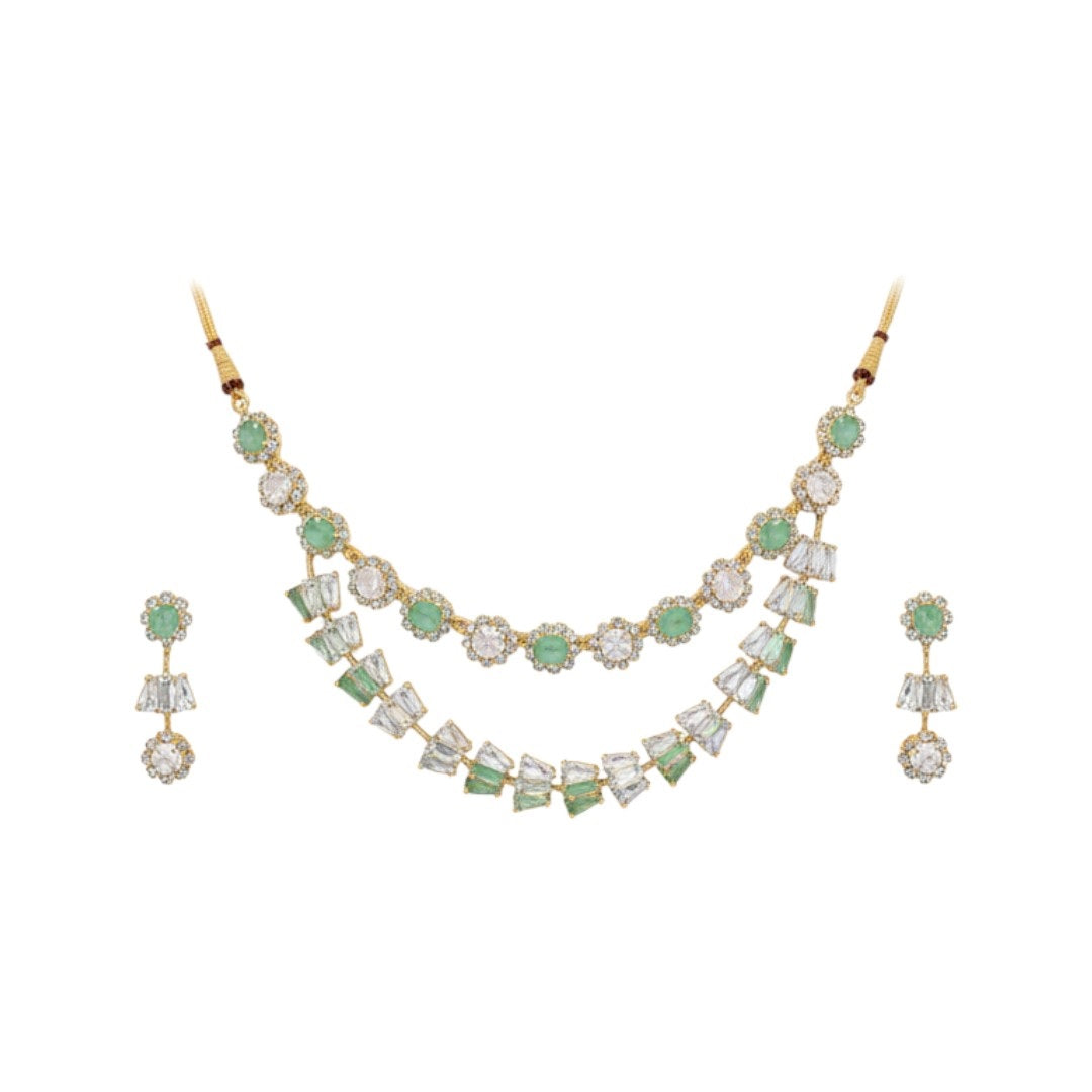 Gold-plated green and white American diamond necklace set with matching earrings on red display stand"