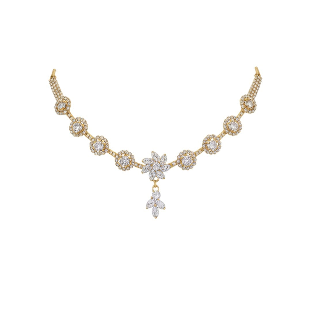 "Gold-plated floral diamond necklace set with matching earrings displayed on red velvet stand – ideal for weddings and festive occasions."
