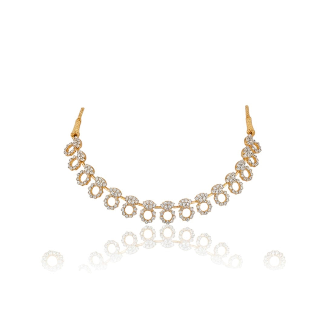 "Gold-plated diamond necklace set with circular motifs and drop earrings on black velvet stand – ideal for party or festive wear."