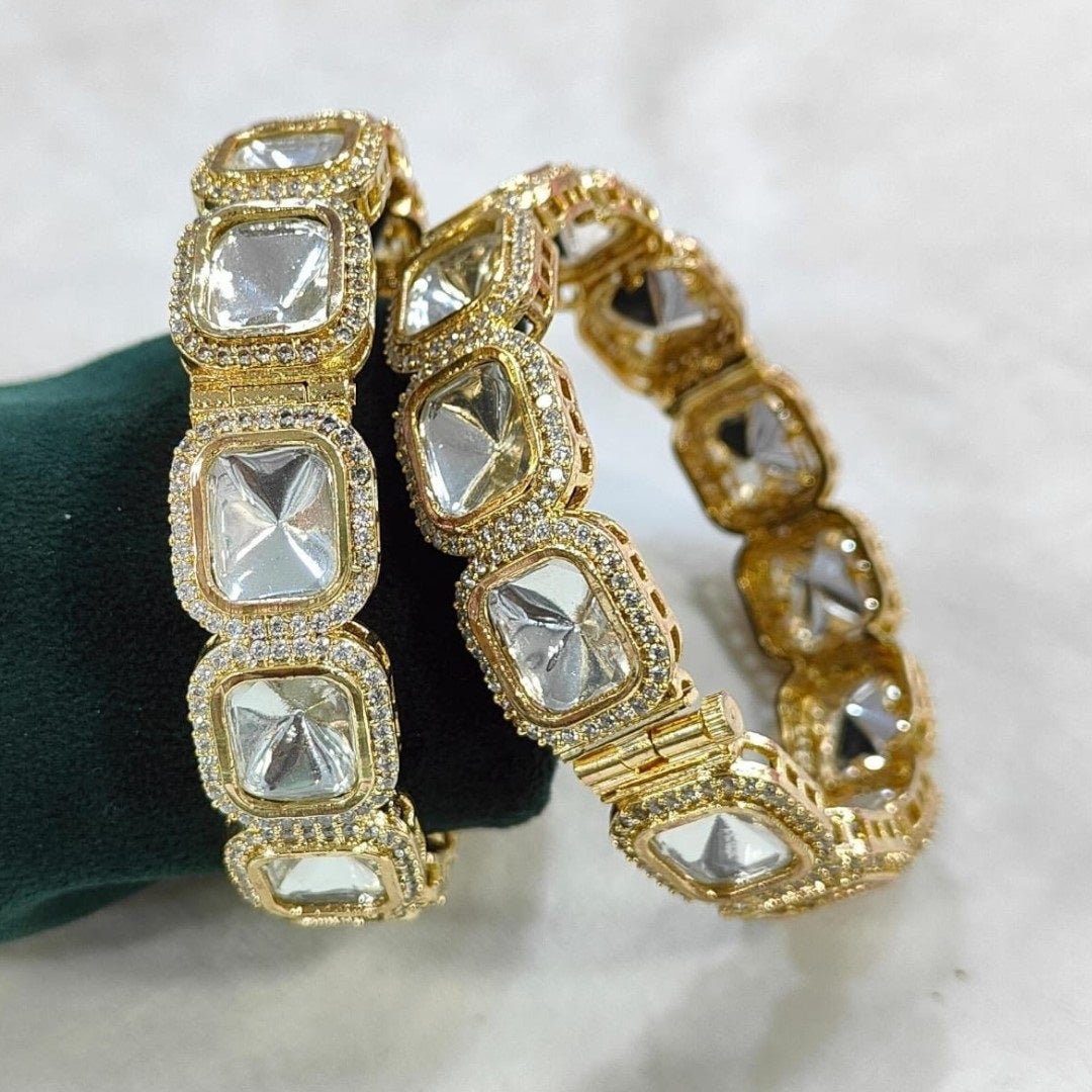Designer Gold - Plated Square Kundan Bangles with Diamond - Cut Mirror Stones - Auraa Trends - Bangles - - Auraa Trends - Close - up of gold - plated square kundan bangles with diamond - cut mirror stones and CZ detailing, displayed on a green fabric roll – traditional Indian bridal jewelry