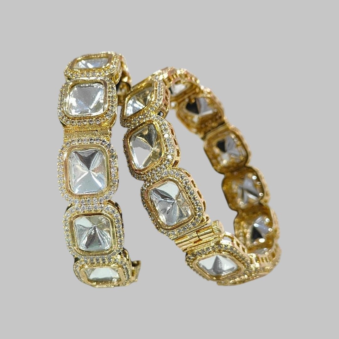 Designer Gold - Plated Square Kundan Bangles with Diamond - Cut Mirror Stones - Auraa Trends - Bangles - - Auraa Trends - Close - up of gold - plated square kundan bangles with diamond - cut mirror stones and CZ detailing, displayed on a green fabric roll – traditional Indian bridal jewelry