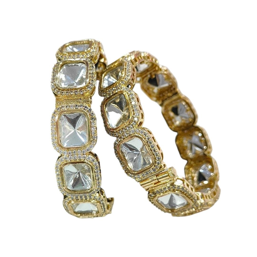 Designer Gold - Plated Square Kundan Bangles with Diamond - Cut Mirror Stones - Auraa Trends - Bangles - - Auraa Trends - Close - up of gold - plated square kundan bangles with diamond - cut mirror stones and CZ detailing, displayed on a green fabric roll – traditional Indian bridal jewelry