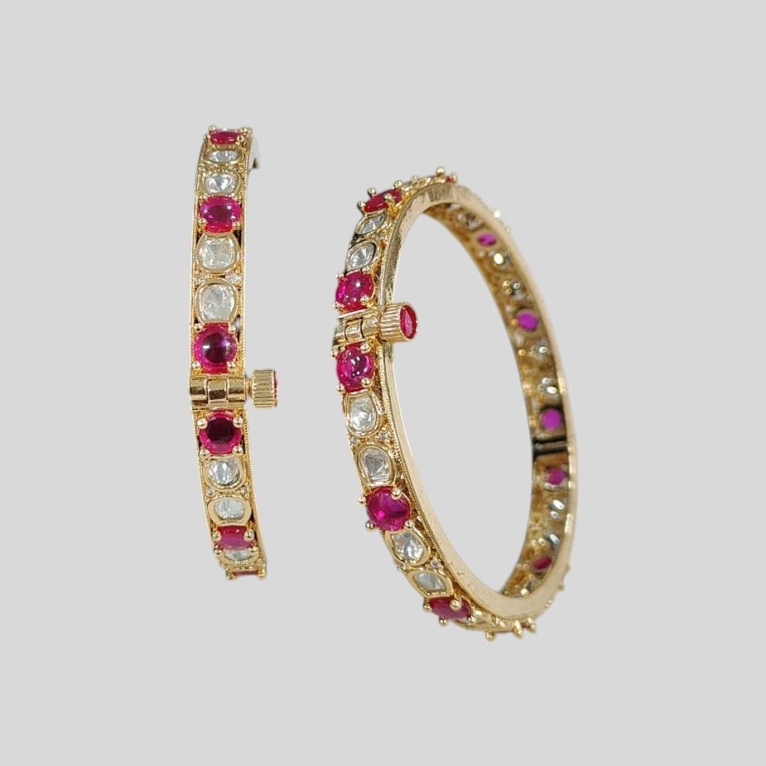 Gold - Plated Bangles with Pink and White Stones - Auraa Trends - Bangles - - Auraa Trends - Gold - plated bangles with alternating pink and white stones, displayed on a green velvet roll against a white background – ethnic kada set for women.