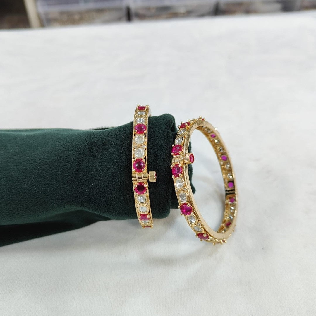 Gold - Plated Bangles with Pink and White Stones - Auraa Trends - Bangles - - Auraa Trends - Gold - plated bangles with alternating pink and white stones, displayed on a green velvet roll against a white background – ethnic kada set for women.