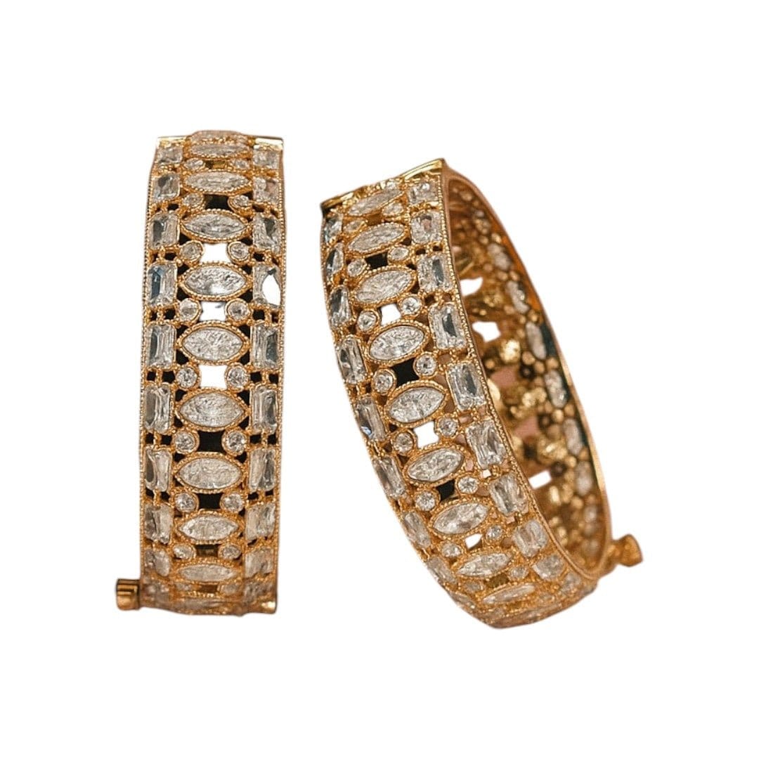 Gold - Plated Designer Bangles with Marquise & Emerald - Cut White CZ Stones - Auraa Trends - Bangles - - Auraa Trends - Close - up of gold - plated bangles adorned with marquise, emerald - cut, and round white CZ stones, displayed on a velvet roll β elegant traditional jewelry for women
