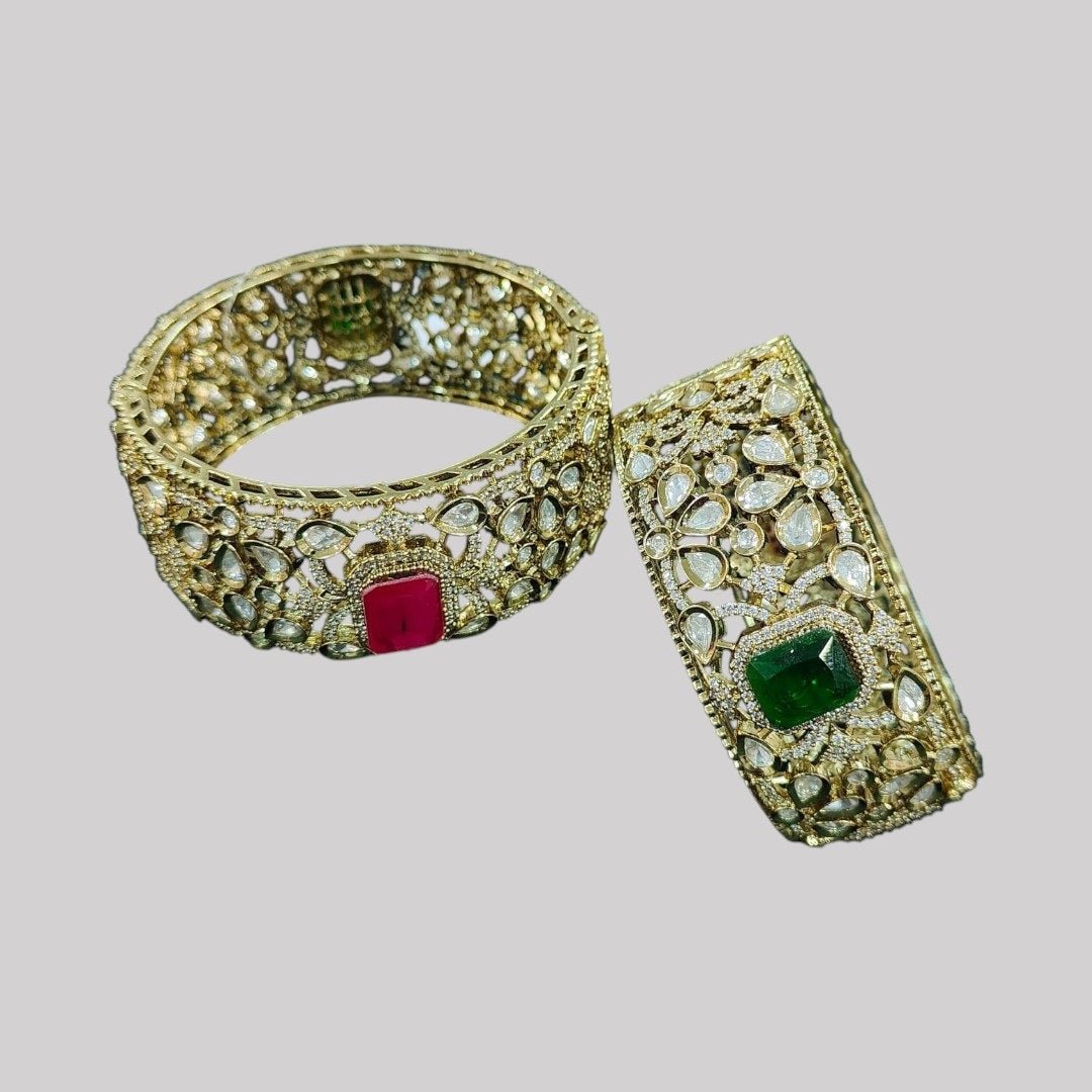 Gold - Plated Kundan Bangles with Pink & Green Square Stone - Auraa Trends - Bangles - - Auraa Trends - Pair of gold - plated traditional kundan bangles with green and pink square center stones, displayed with floral decor on textured background.โ