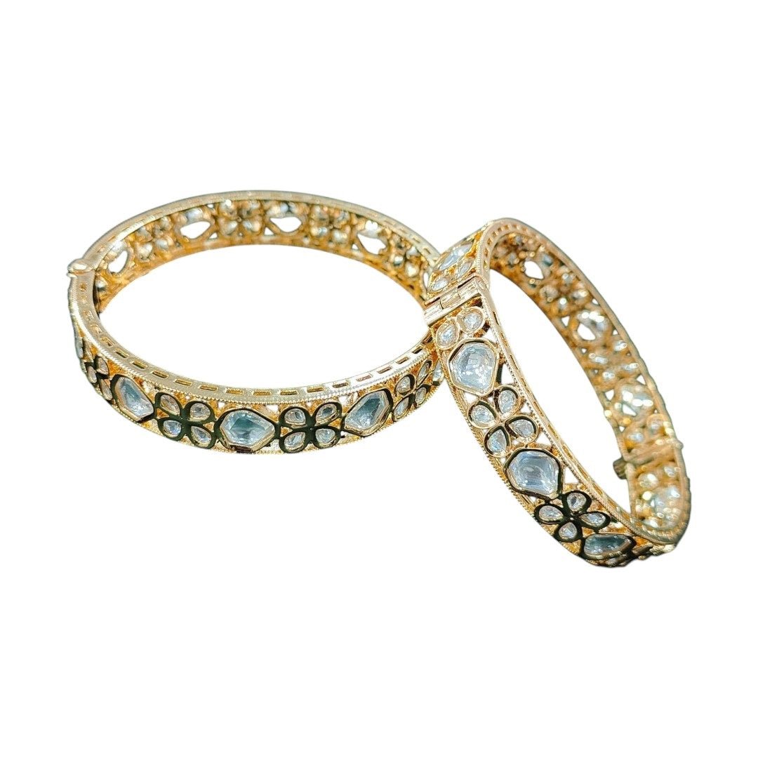 Gold - Plated Kundan Floral Bangles with White Stones - Auraa Trends - Bangles - - Auraa Trends - “Gold - plated traditional bangles with white kundan stones and floral motifs – set of 2 on green velvet background.”