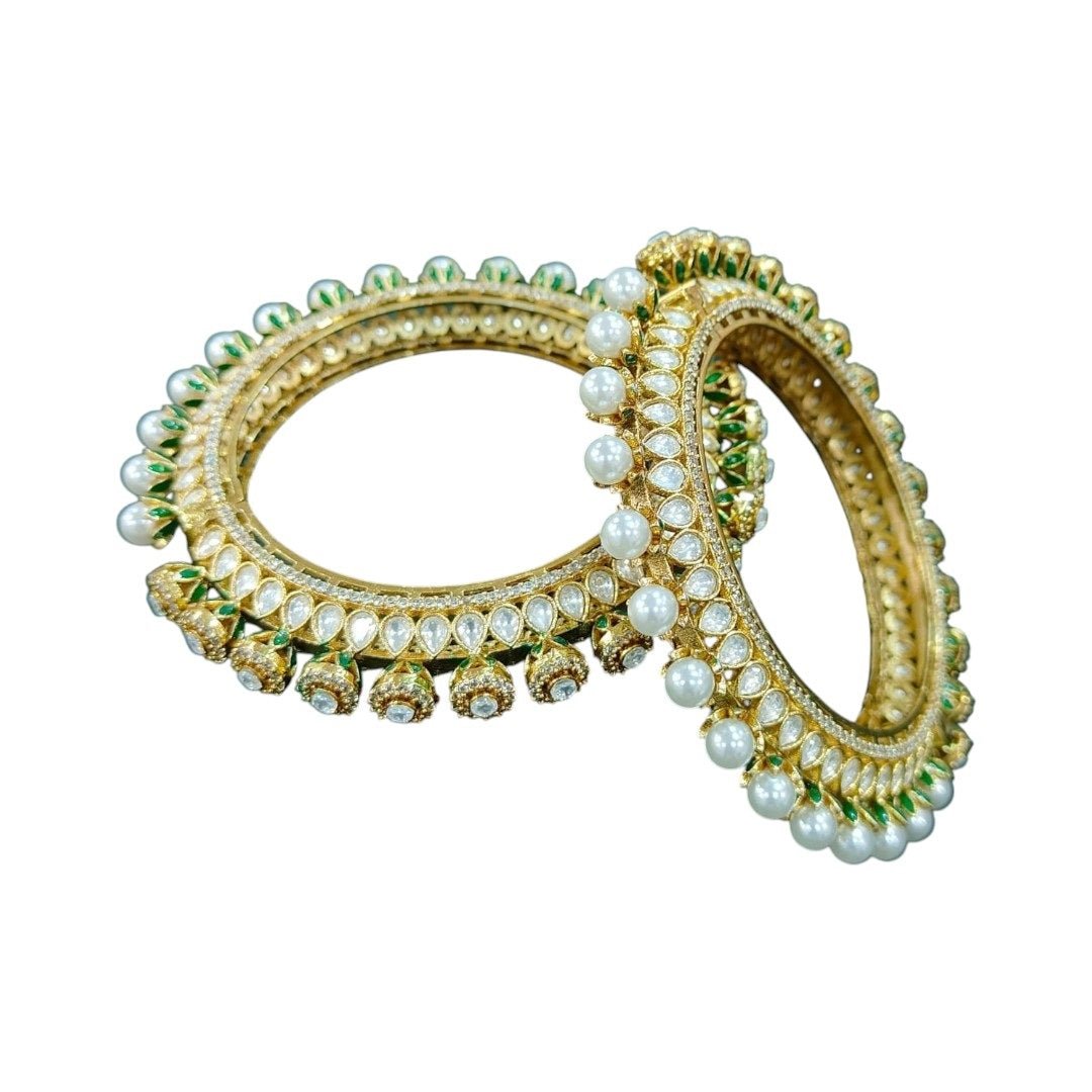 Gold - Plated Pearl & Kundan Bangles with Green Enamel Detailing - Auraa Trends - Bangles - - Auraa Trends - Gold - plated bangles with kundan stones, pearl embellishments, and jhumka - style hanging drops, displayed on dark green velvet background