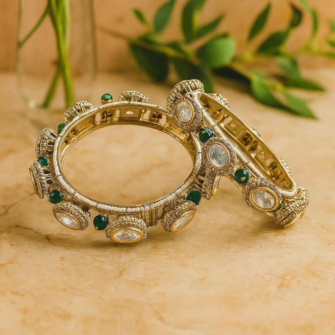Gold - Plated Traditional Kundan Bangles with Green Beads and Dome Motifs - Auraa Trends - Bangles - - Auraa Trends - Close - up of gold - plated traditional kundan bangles with oval white stones, antique dome motifs, and green bead detailing β bridal ethnic jewelry for women