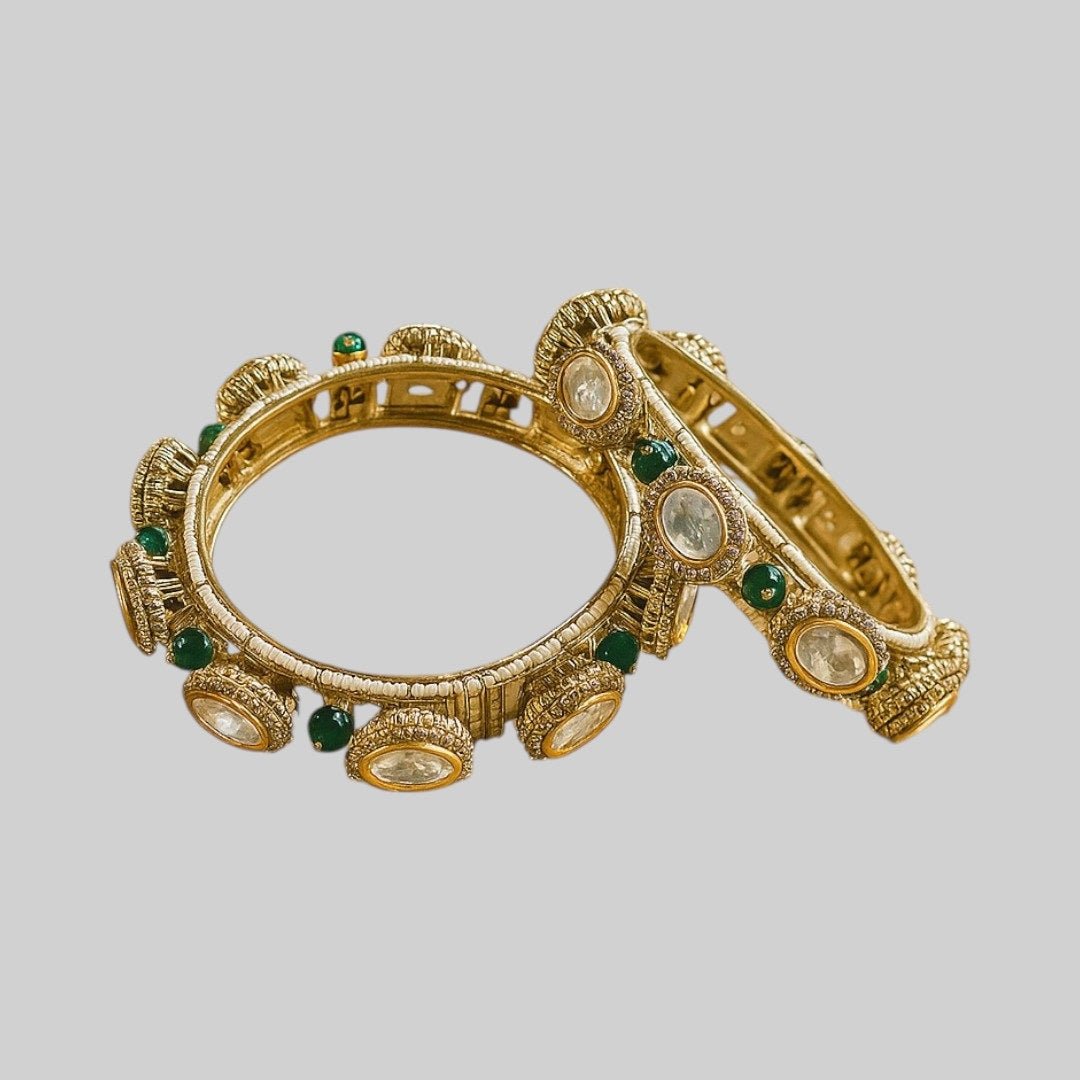 Gold - Plated Traditional Kundan Bangles with Green Beads and Dome Motifs - Auraa Trends - Bangles - - Auraa Trends - Close - up of gold - plated traditional kundan bangles with oval white stones, antique dome motifs, and green bead detailing β bridal ethnic jewelry for women