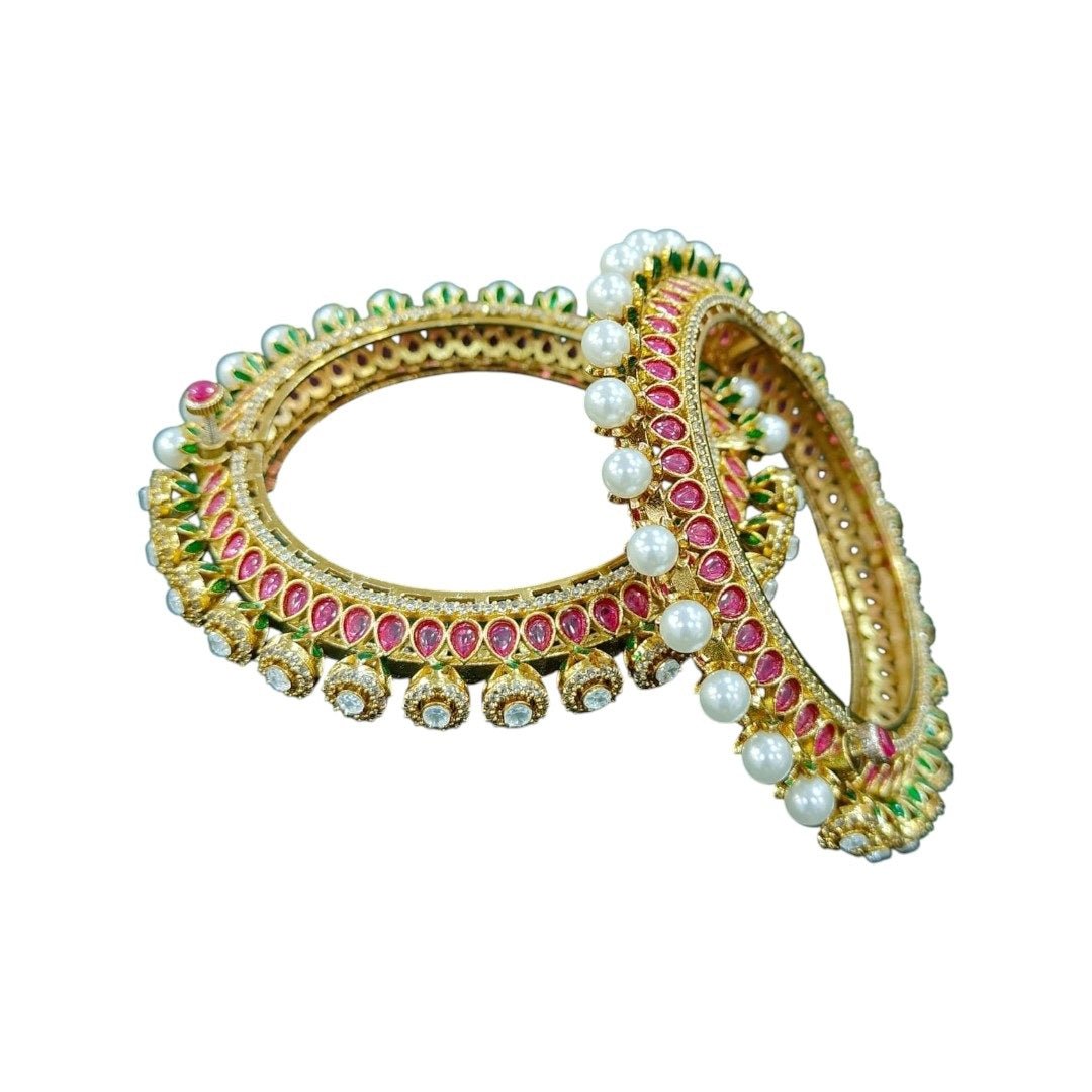 Gold - Plated Traditional Red Enamel Bangles with Pearl & Kundan Detailing - Auraa Trends - Bangles - - Auraa Trends - “Traditional gold - plated bangles with red enamel, pearl beading, kundan stones, and green detailing – set of 2 on green velvet background.”