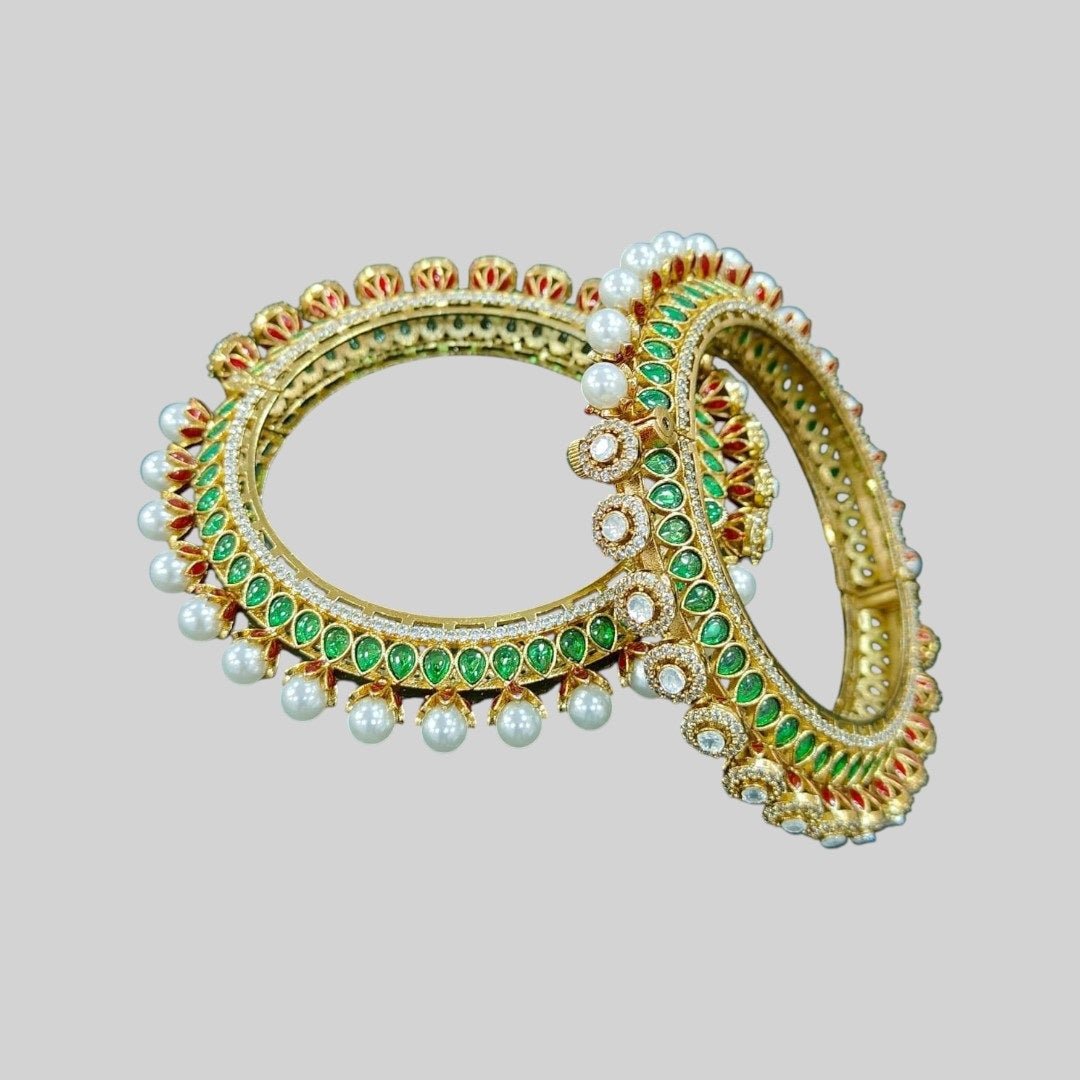 Traditional Gold - Plated Kundan & Pearl Studded Bangles with Green & Red Enamel Work - Auraa Trends - Bangles - - Auraa Trends - “Traditional gold - plated bangles with green and red enamel, kundan stones, and pearl detailing – set of 2 on velvet background.”