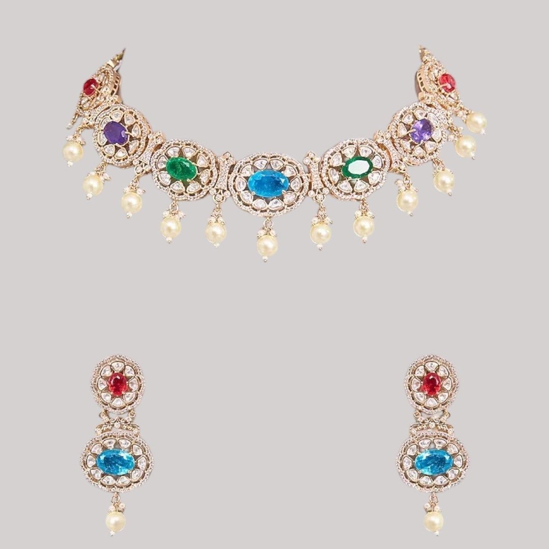 Traditional Gold - Tone Pearl Drop Multicolor Choker Necklace Set with Earrings for Women - Auraa Trends - Necklace Set - - Auraa Trends - Woman wearing a gold - tone multicolor gemstone choker necklace with pearl drops and matching earrings, styled with an embroidered saree blouse.