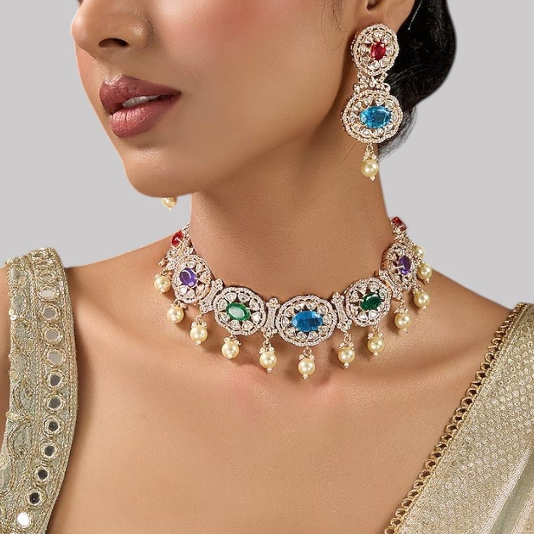 Traditional Gold - Tone Pearl Drop Multicolor Choker Necklace Set with Earrings for Women - Auraa Trends - Necklace Set - - Auraa Trends - Woman wearing a gold - tone multicolor gemstone choker necklace with pearl drops and matching earrings, styled with an embroidered saree blouse.