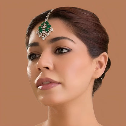 Gold finish American diamond maang tikka with emerald green pear stones, clear zircon accents and a leaf-shaped zircon chain – Auraa Trends