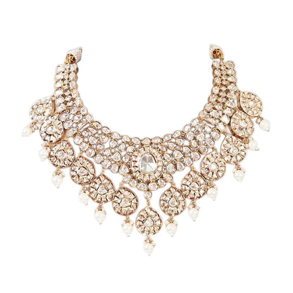 Gold-tone polki kundan choker necklace with teardrop medallions and pearl drops, shown with matching chandelier earrings