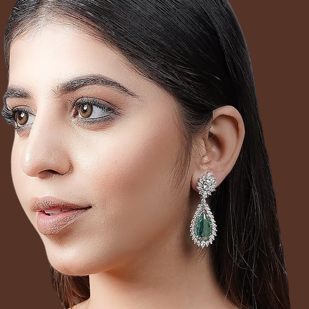 Emerald green teardrop dangle earrings with sparkling crystal floral halo design

