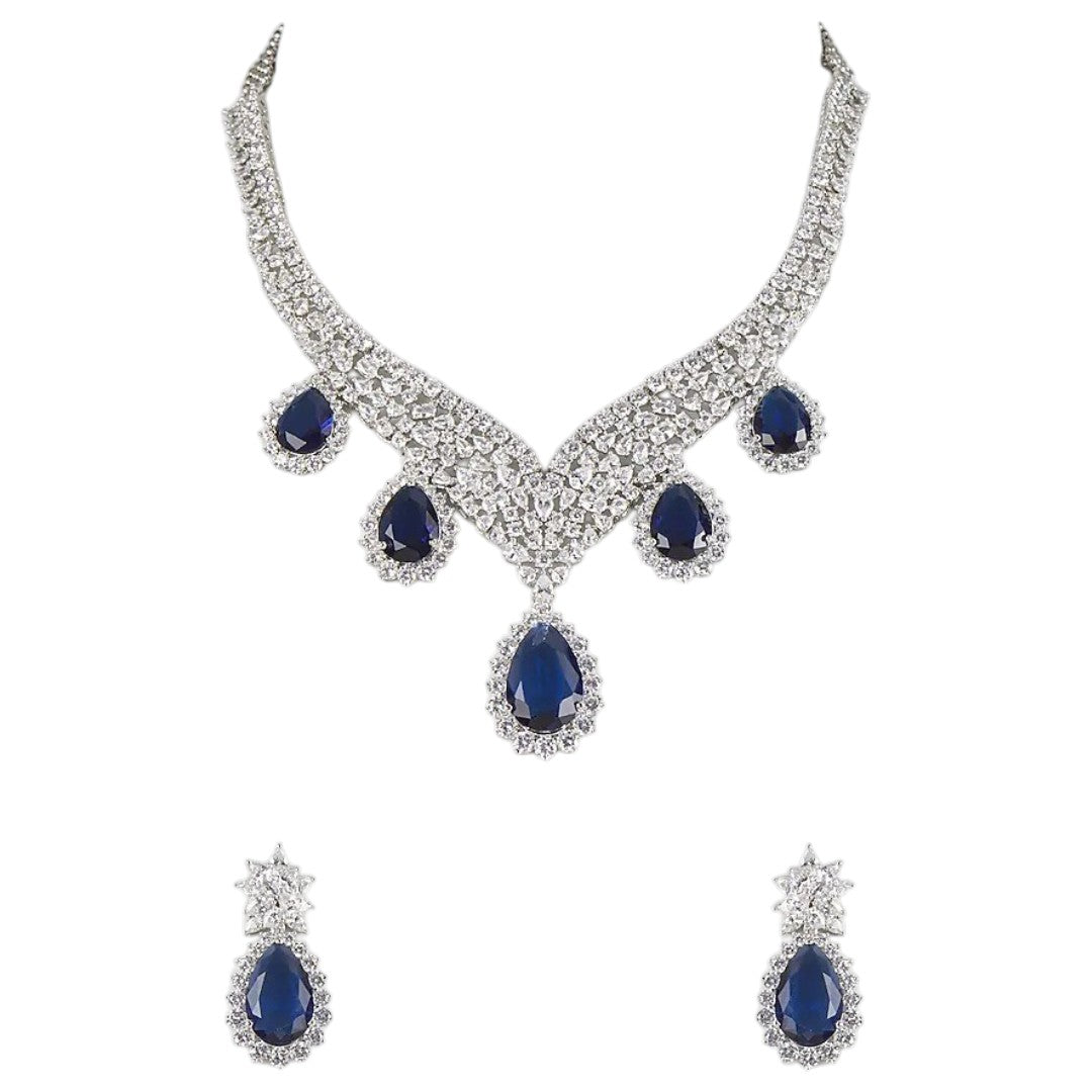 "Silver rhodium-plated V-shaped necklace set with white American diamonds and blue sapphire pear-drop stones, paired with matching teardrop earrings"