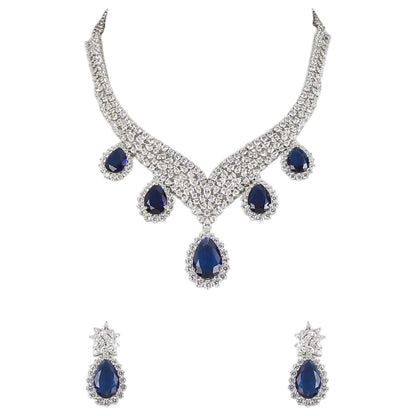 "Silver rhodium-plated V-shaped necklace set with white American diamonds and blue sapphire pear-drop stones, paired with matching teardrop earrings"
