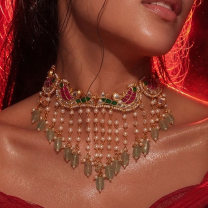 "Gold-plated Kundan Meenakari choker necklace and earring set with pearl and green bead drops, styled bridal jewellery on model"