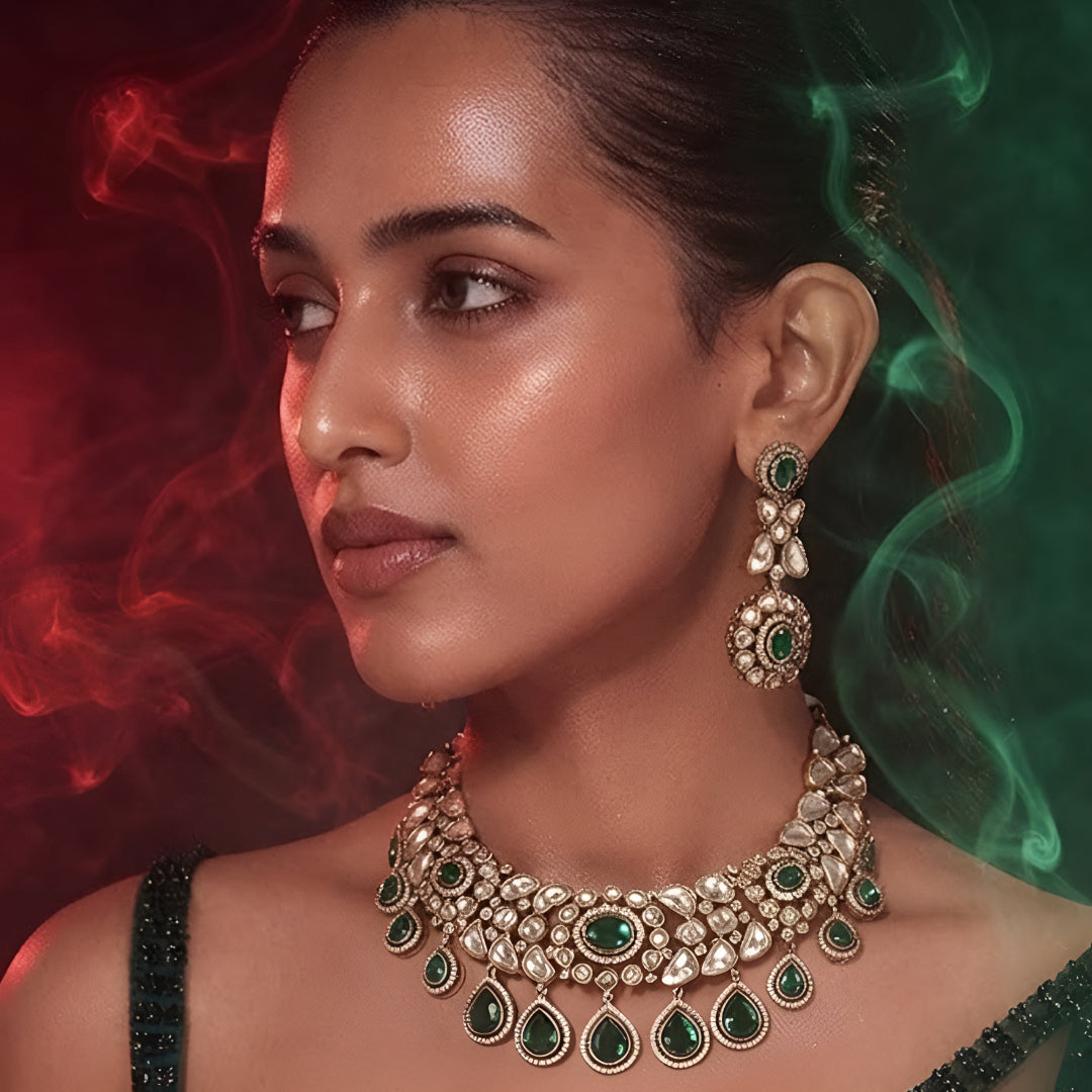 "Gold-tone Kundan choker necklace set with emerald green teardrop drops and matching earrings"
